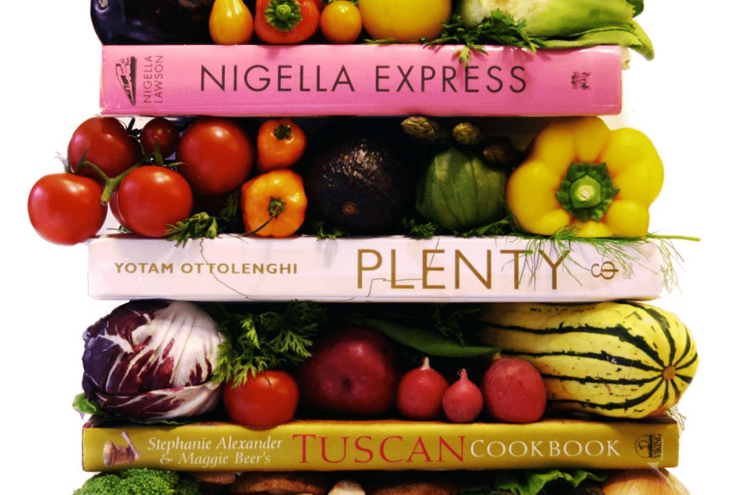 A pile of recipe books and produce